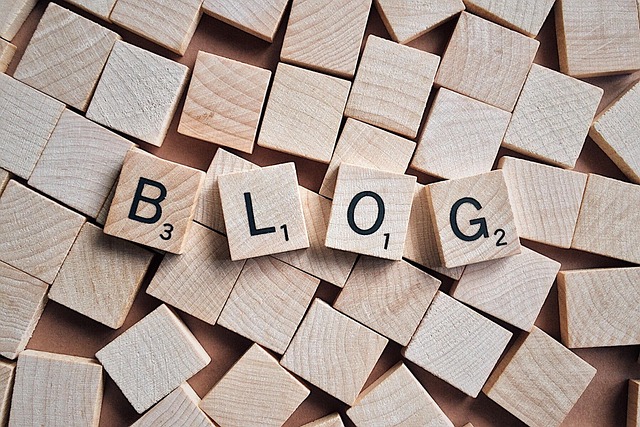 Wooden tiles spelling 'BLOG' placed among scattered blank tiles.