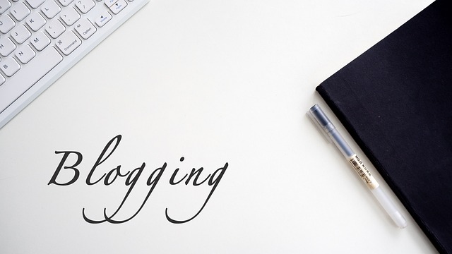 A minimalist blogging workspace with a keyboard, notebook, and pen—ideal for content creation inspiration.